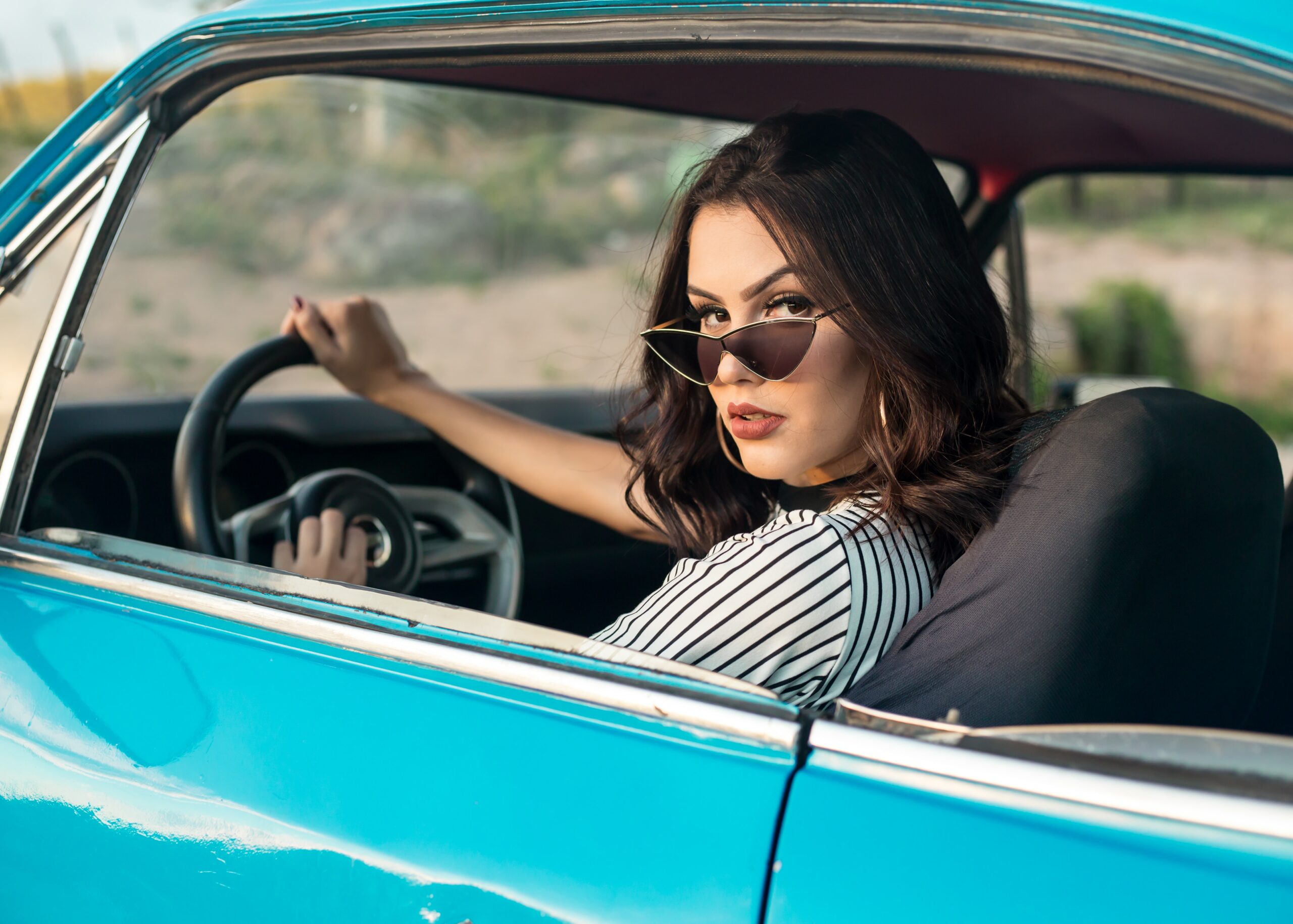 Girl driving a car with headphones. 